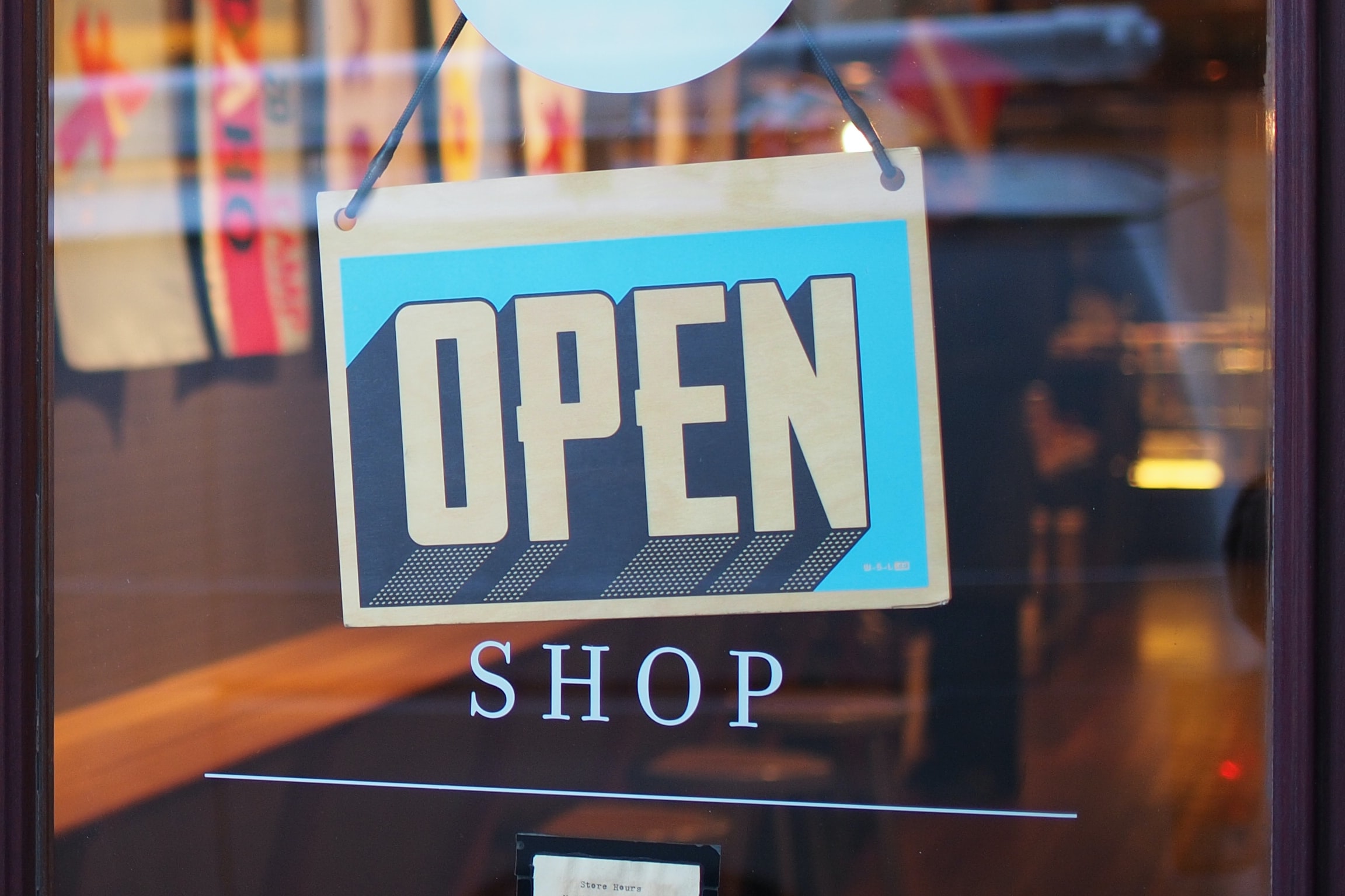 'Open' sign on retail store front door.